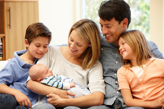 Family with mother holding new baby